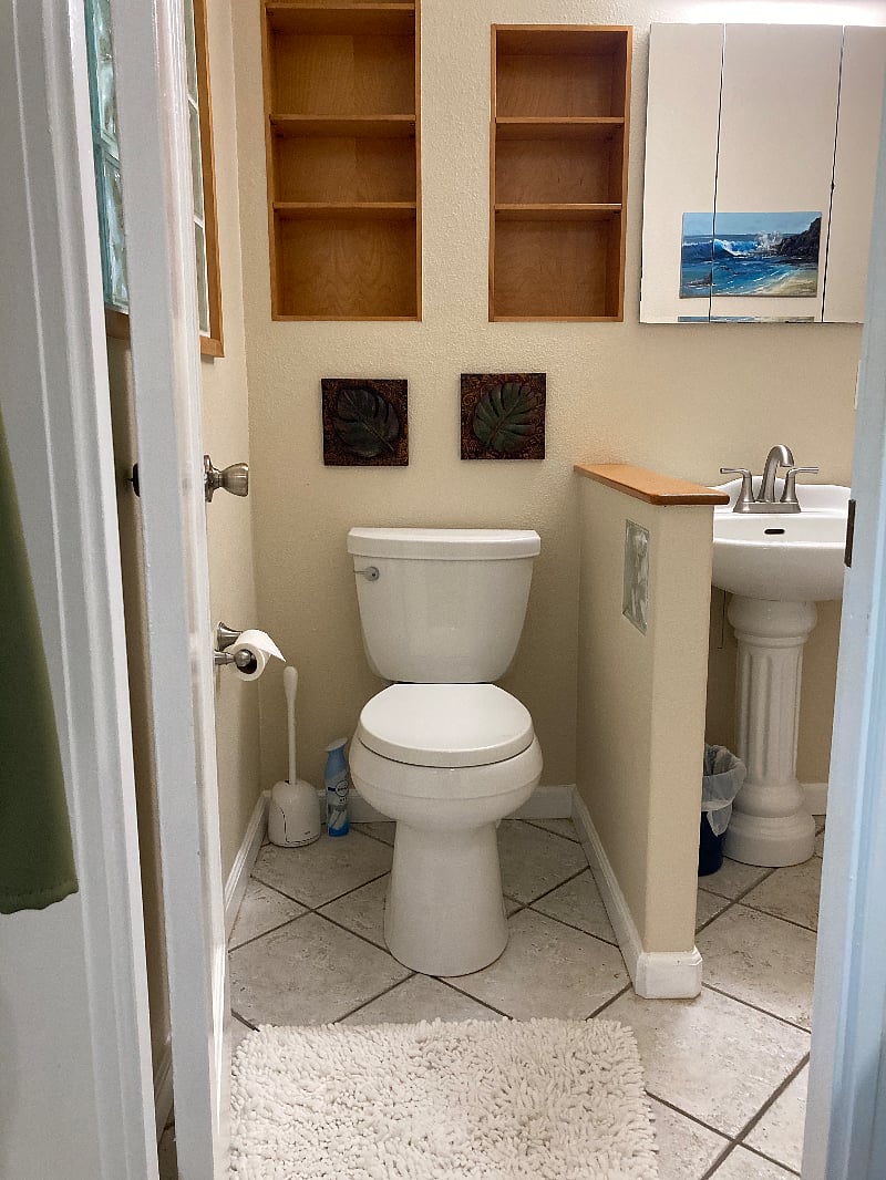 A view of the bathroom that contains plenty of storage space,