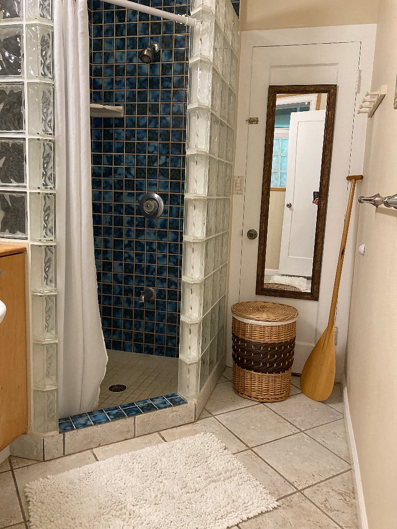 A view of the bathroom with a standup shower.