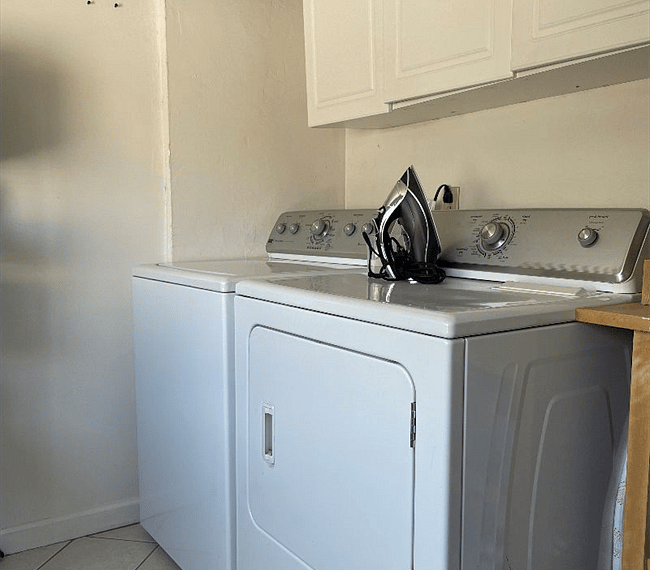Laundry room/storage room with full size washer/dryer and storage racks