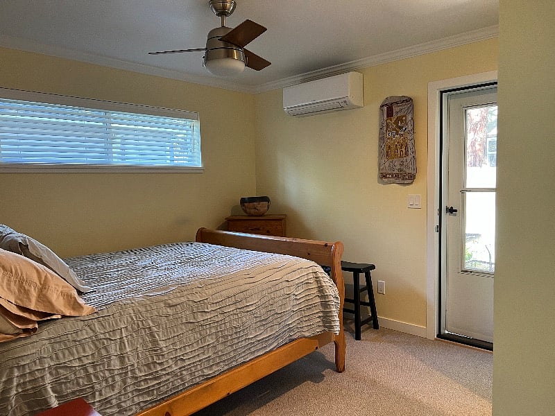 another view of bedroom with backdoor and screen door