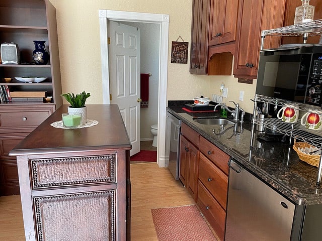This picture is of the kitchen and is also a photo of the door leading you into the bathroom. Opposite this photo is a nice size TV