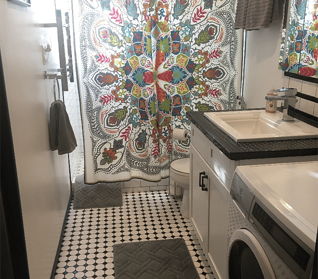 newly remodeled bathroom with towel warmer and washing machine.  