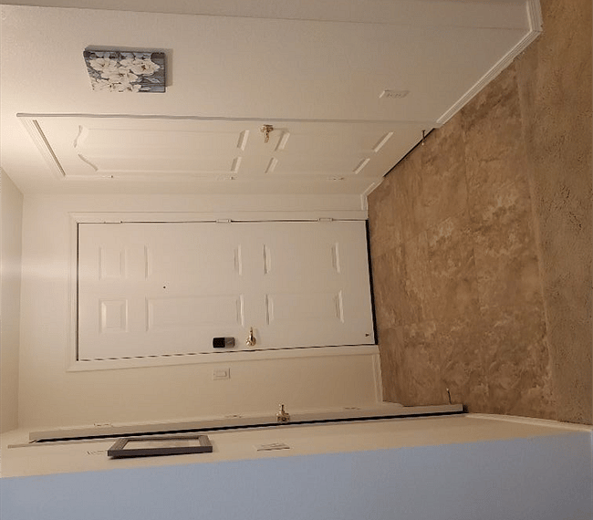 Entry door wth laundry to the left and hot water heater and storage closet to the right