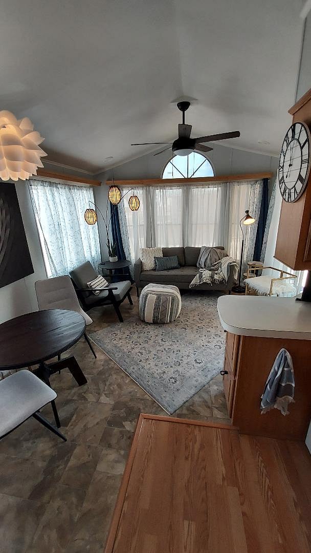 the kitchen overlooks the living, dining areas
