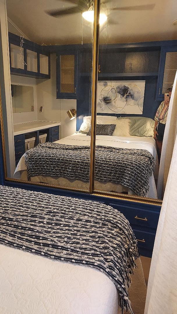 the queen bed with luxury linens and accent lighting 