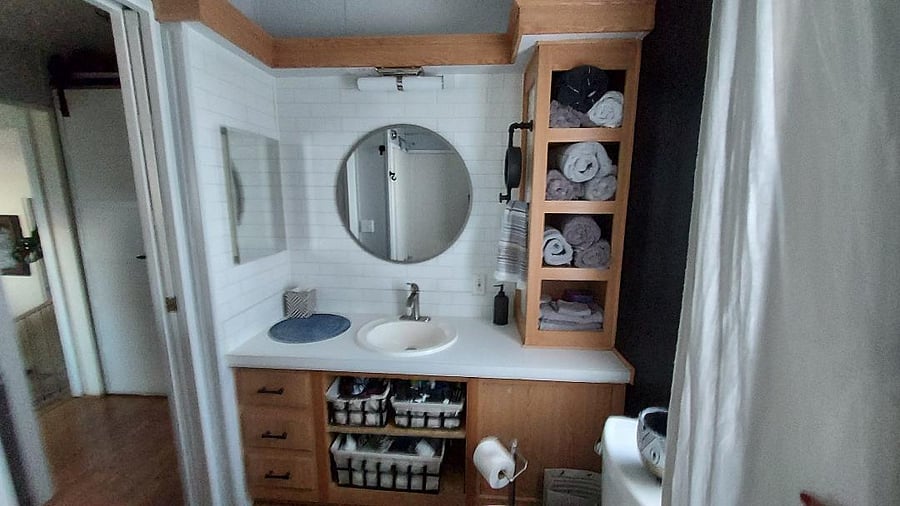 the bathroom with organizing bins and thirsty towels