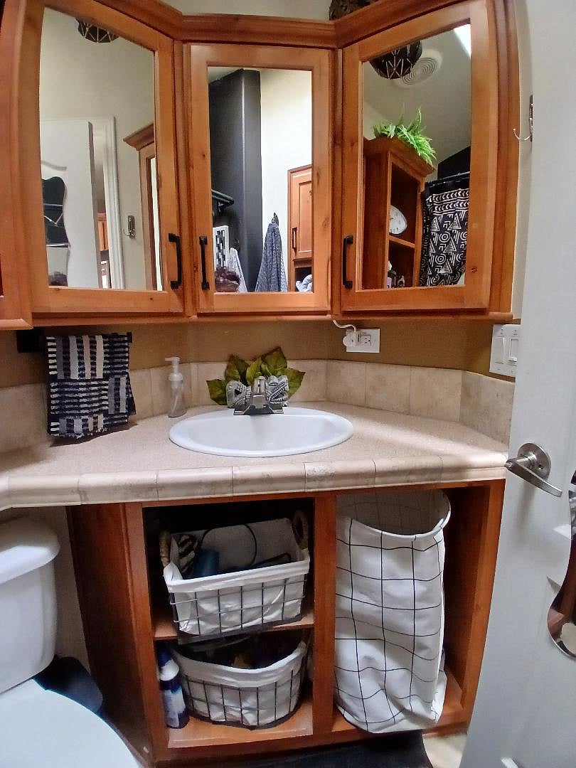 the bathroom with organizing bins and thirsty towels
