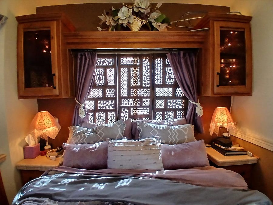 the moroccan headboard with black out drapes and accent lighting