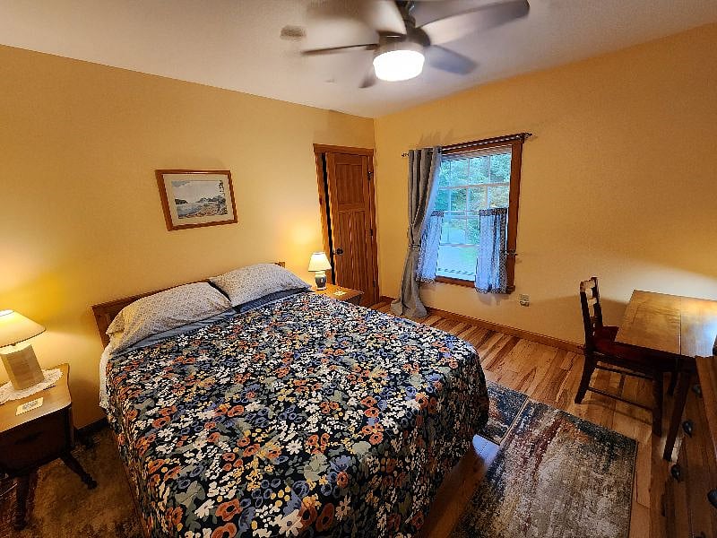 Bedroom features view of Hunger Mt, walk-in closet, a desk, and a couple bureaus