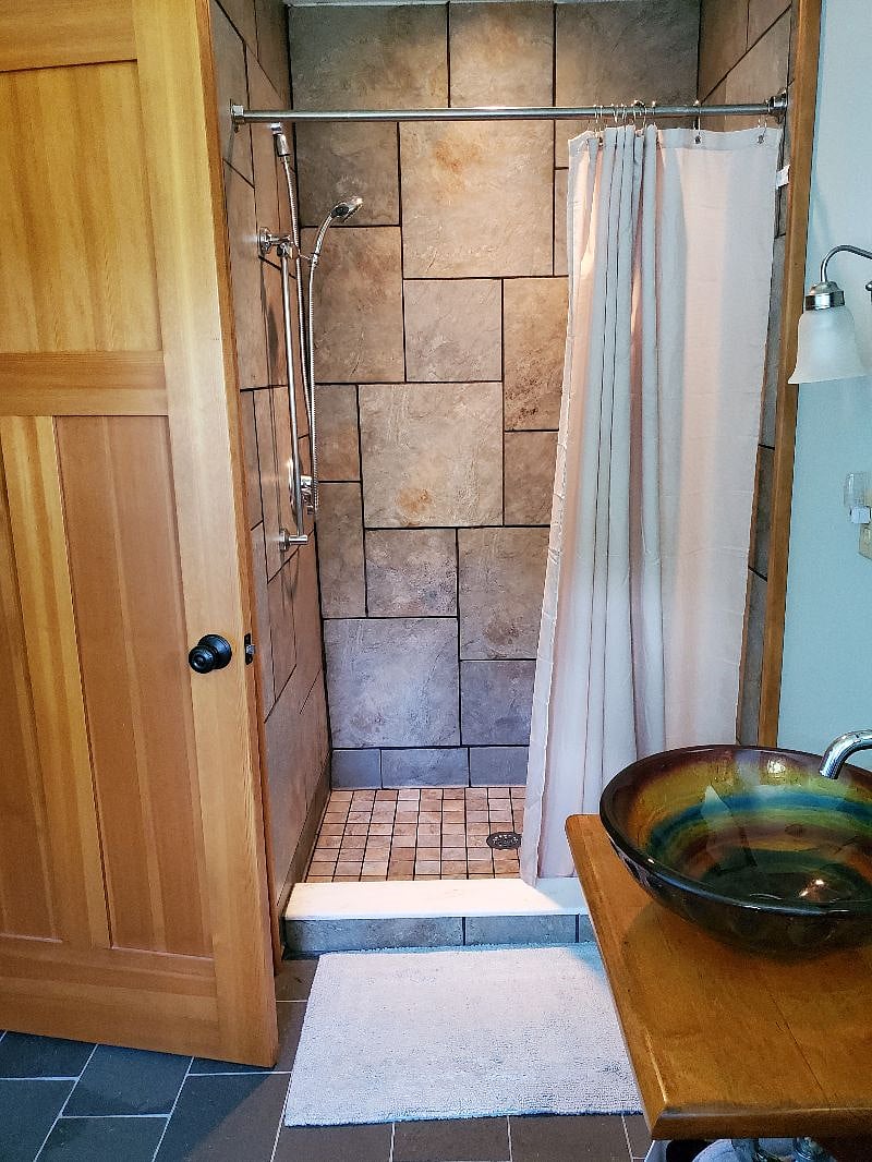 Bathroom features Franciscan tile shower, artisan glass bowl sink, heated floor & heatlamp, plus a Stowe view!