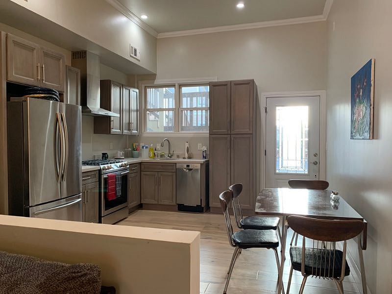 Modern Kitchen with back door to gated parking. One spot available for our condo.