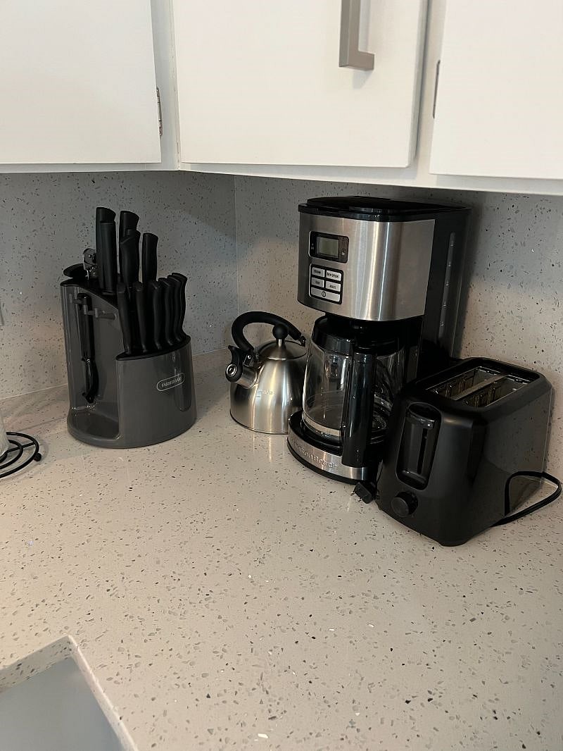 New countertops and corresponding backsplash adorn the ample kitchen