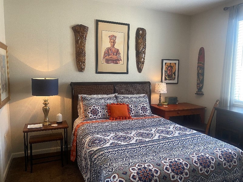 Queen size bed with eclectic artwork from around the world!