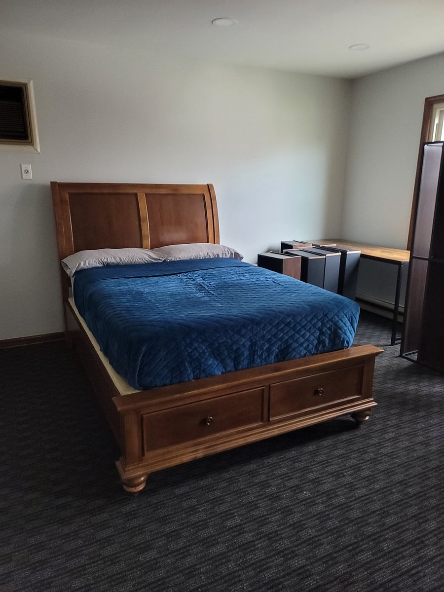 Master bedroom with desk and 55 inch smart TV.