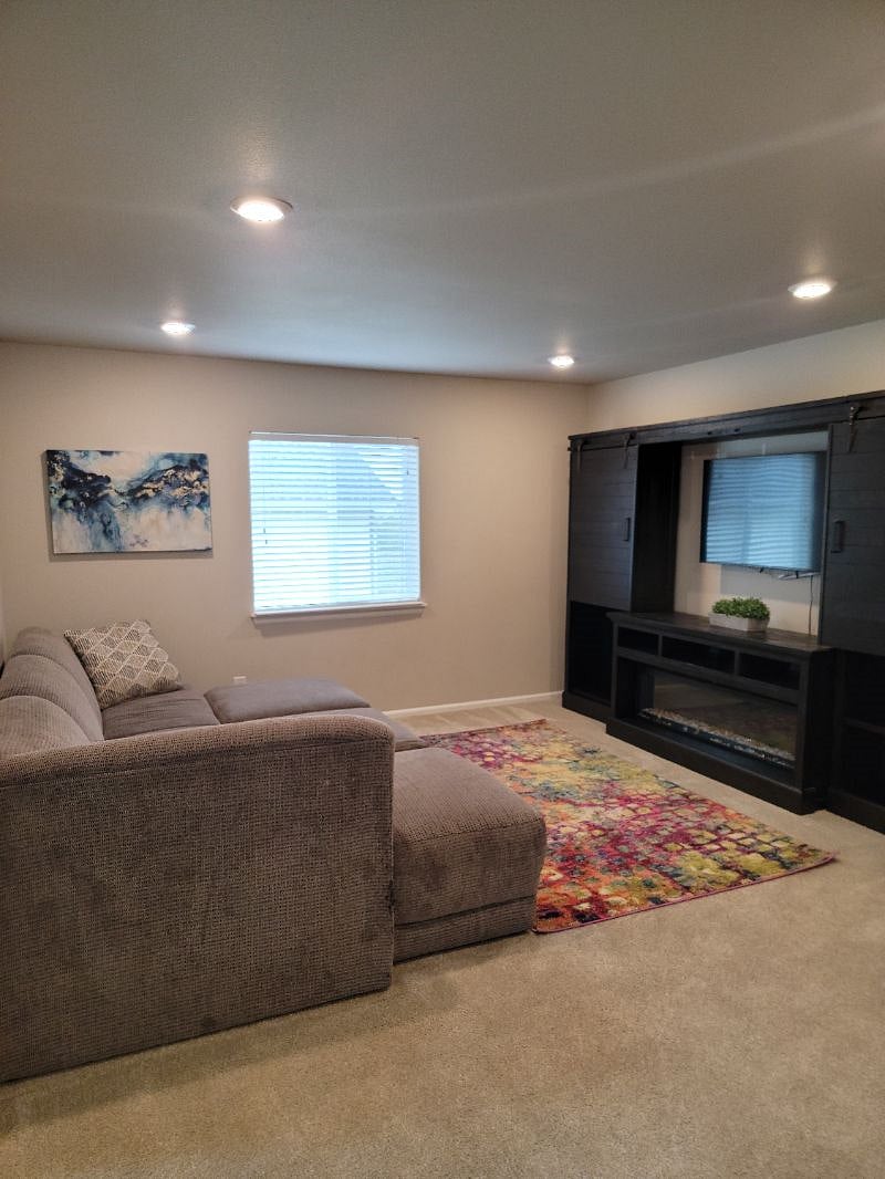 Bonus room right outside your door for a relaxing movie night. Electric fireplace will keep you cozy!