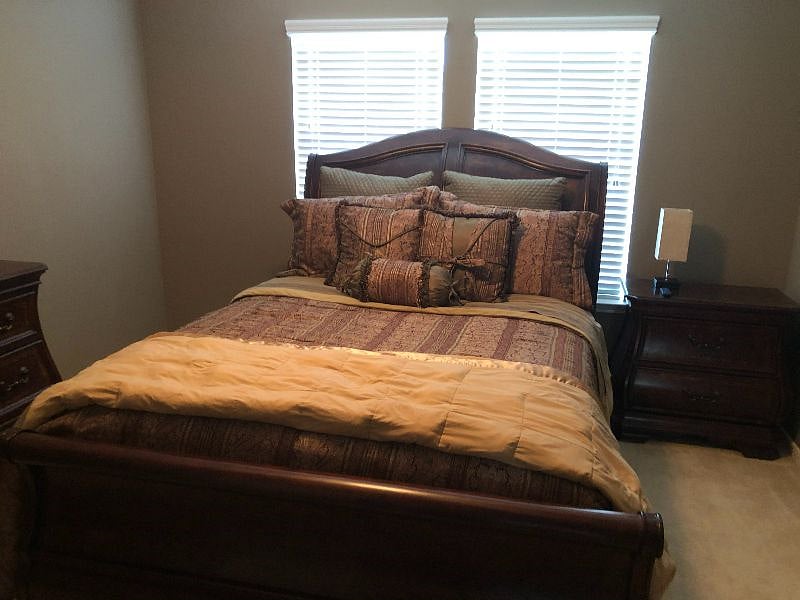 Private bedroom #2 with queen size bed, walk-in closet, remote-control ceiling fan, and a smart tv.