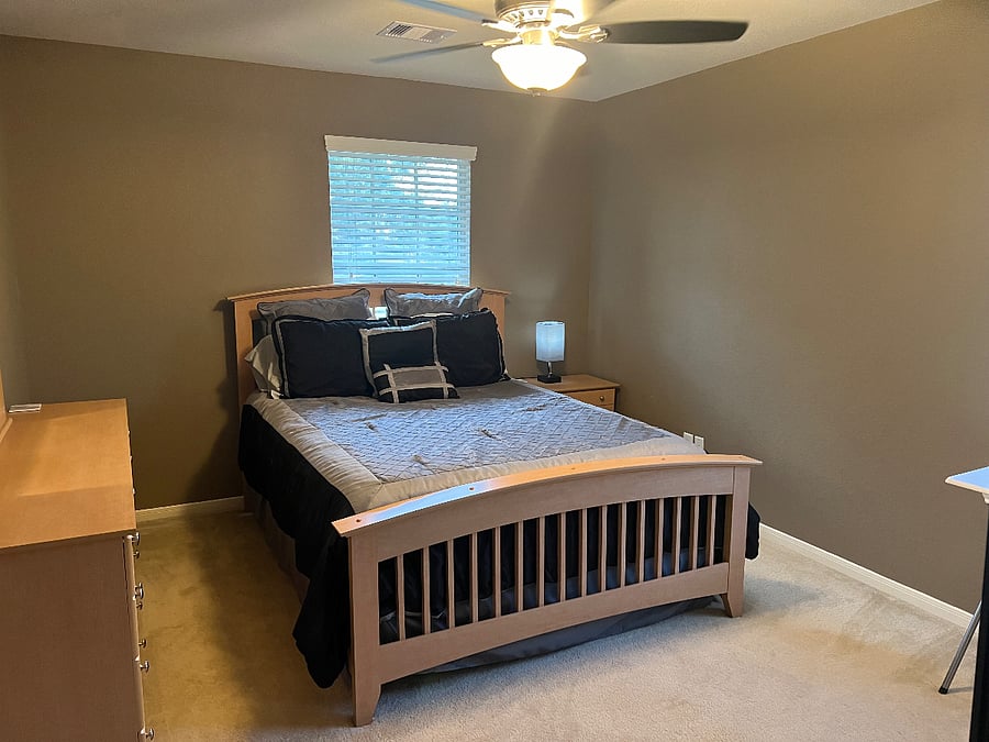 Private bedroom #1 with queen size bed, walk-in closet, remote-control ceiling fan, and a smart tv.