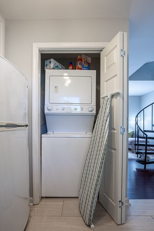 laundry area including an iron and ironing board.