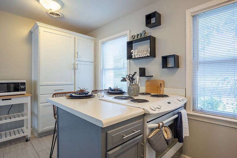 island seating, additional cabinets and pantry, microwave.