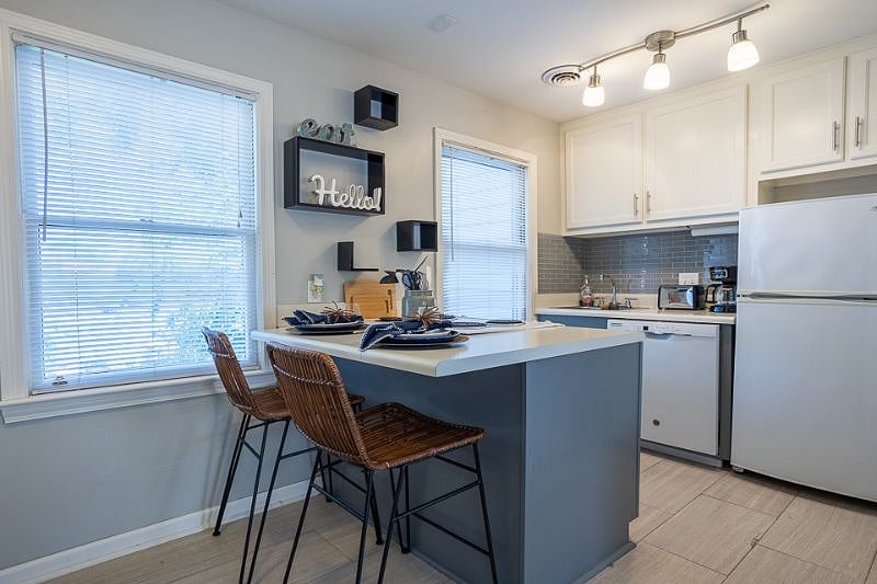 Island seating. Fully stocked kitchen from toaster, coffee maker, microwave, mixer, po