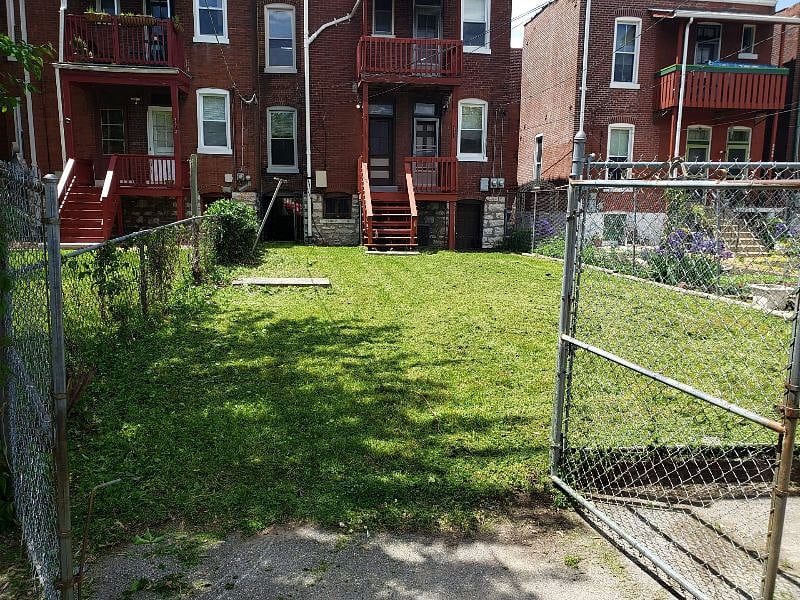 Backyard - view from alley toward the back of the house. You can see the decks which are accessible from the kitchens.