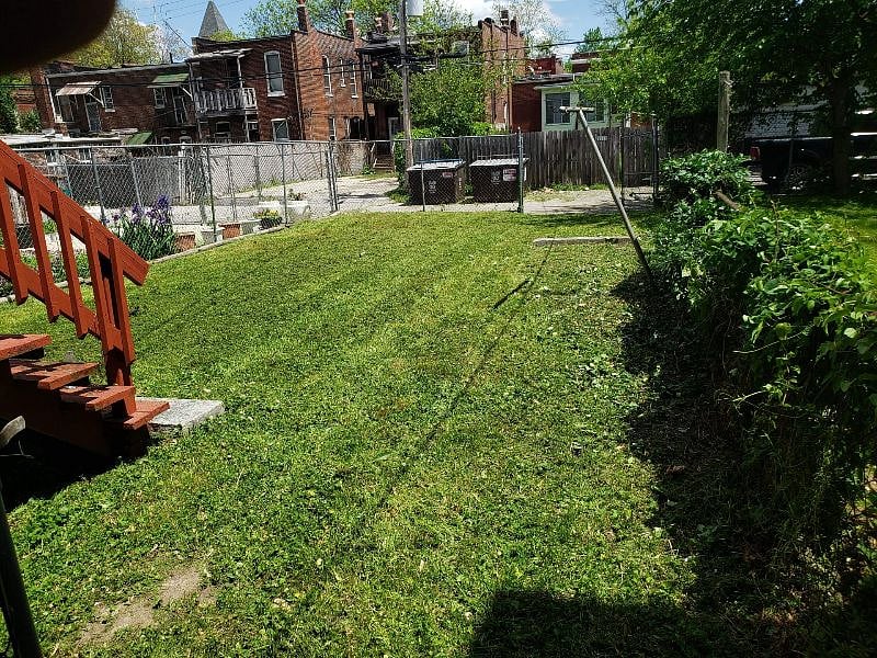 Fenced backyard with swing out gate.