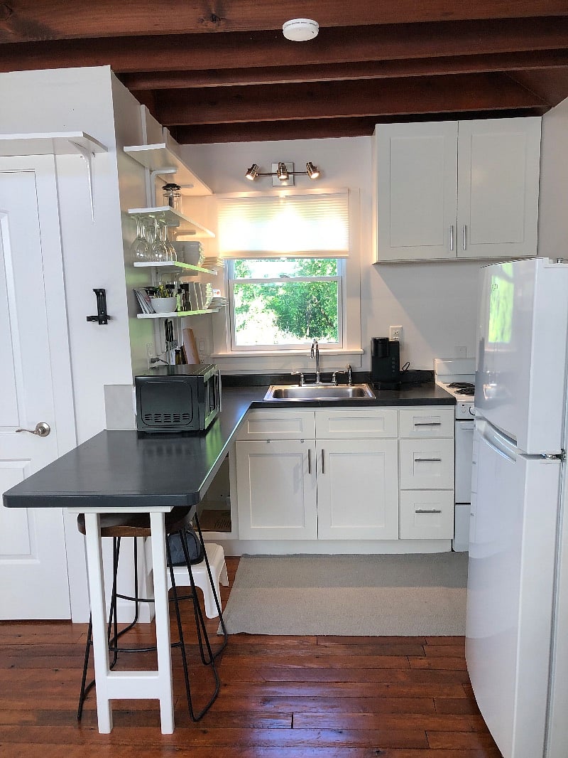 Full kitchen with apartment sized stove and refrigerator.