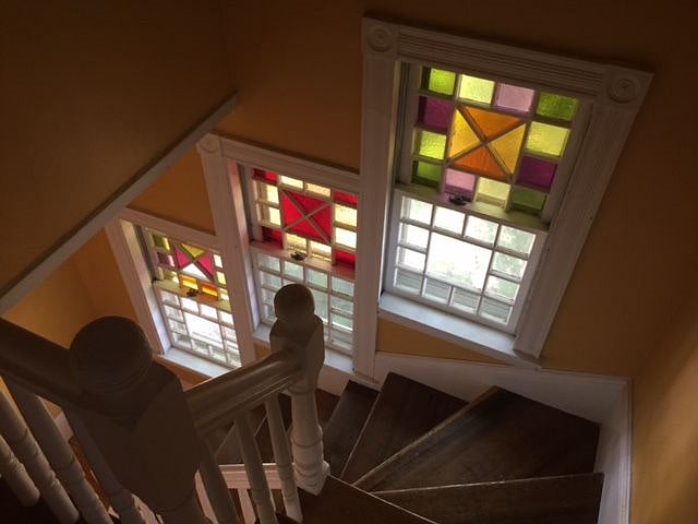 Stained glass windows and hardwood floors. 