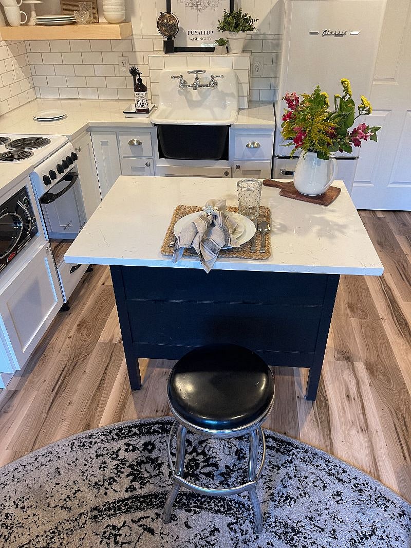 Kitchen island serves as storage, eating bar and work space