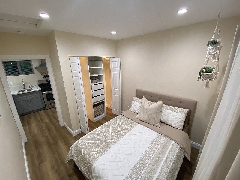 Cozy bedroom with full-size bed, spacious closet, and blackout blinds for quality rest.
