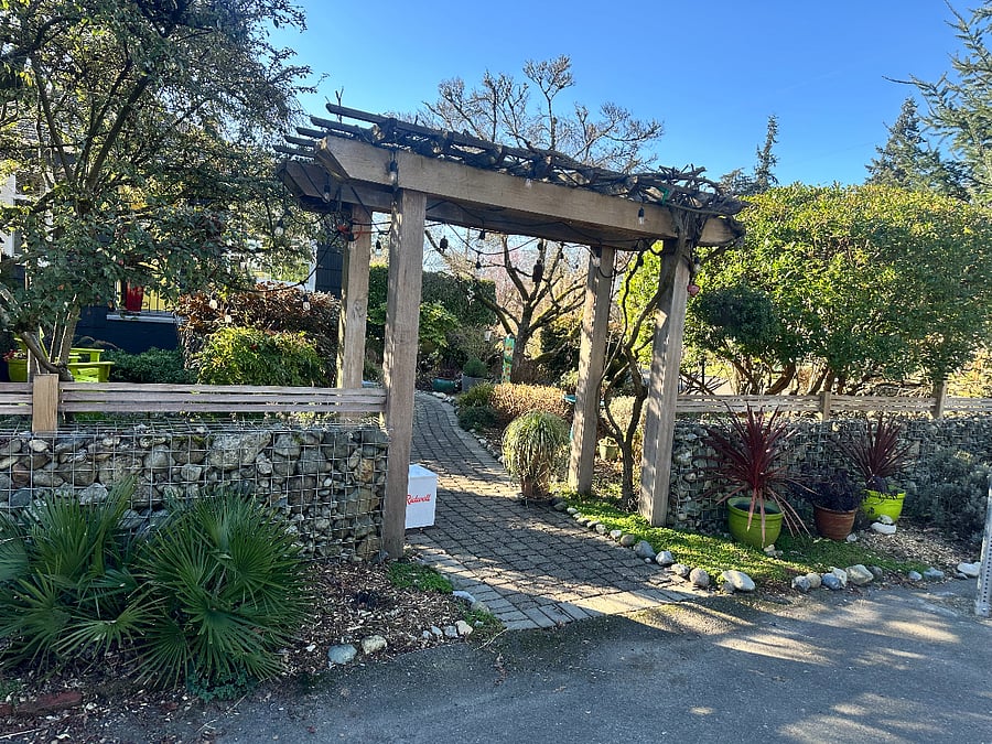 This is the view from the street with the gabion fence- you sweet little sitting area is to your right on your way to the front door
