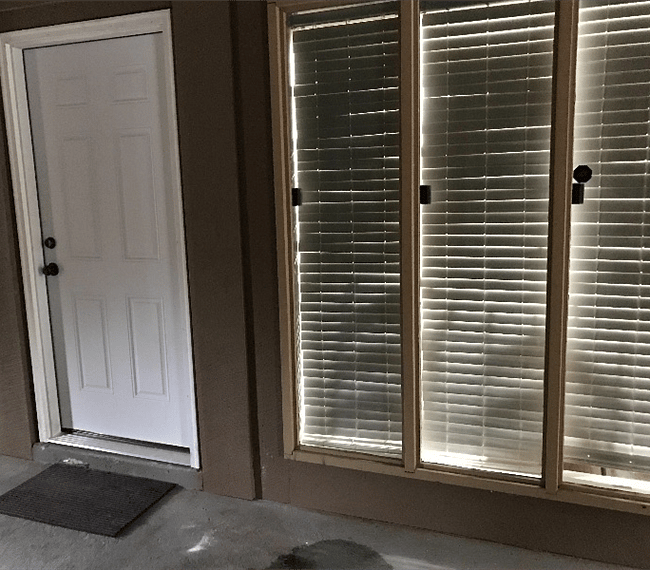 Front door; windows looking  into dining room area