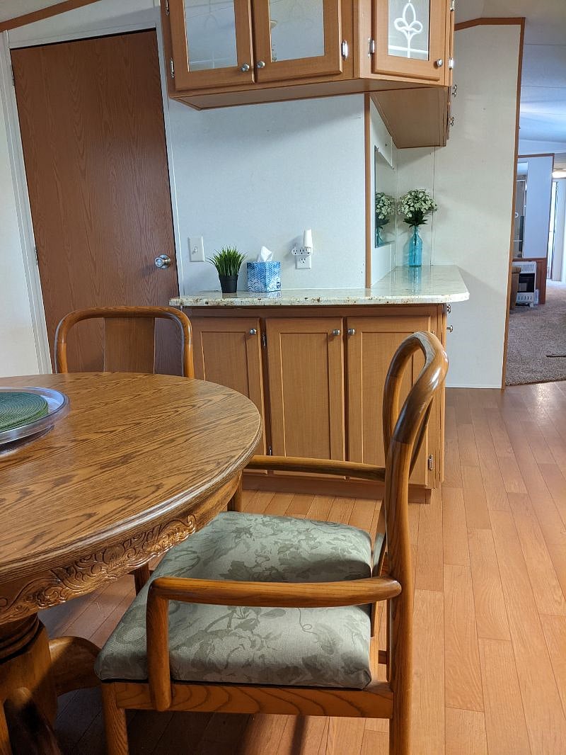 Granite countertop in dining area. Notice freestanding propane heater in background - that is for emergency heat in case of a power outage. Home has a central hvac system.
