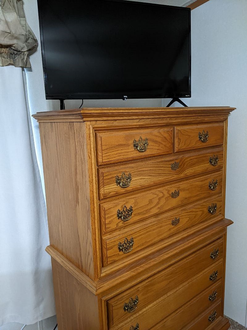 Chest of drawers and smart TV in master bedroom