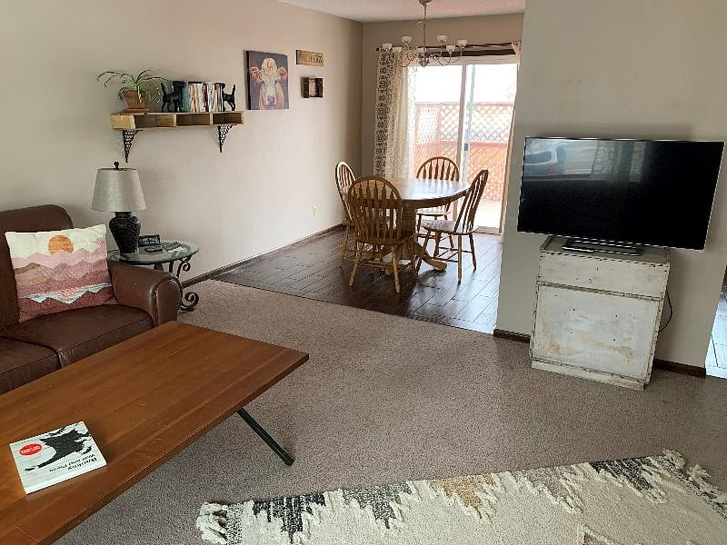 Open floor plan - living room looking into the dining area. To the right of the TV opens into the kitchen. 