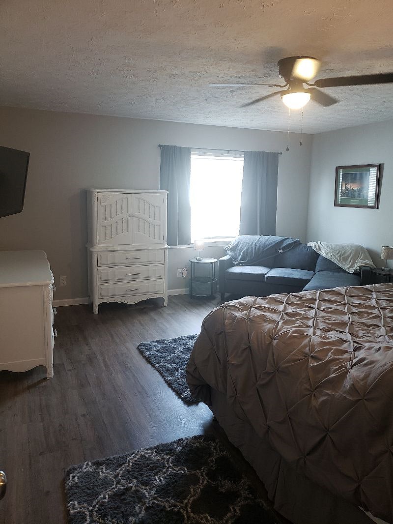 Huge bedroom with a king bed, 50" smart tv, vanity sitting area and dedicated work space/desk in this room. Also an additional couch/sitting area set-up.