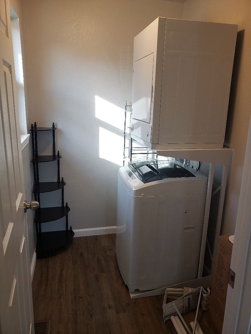 Stacked laundry in the closet off the bedroom.