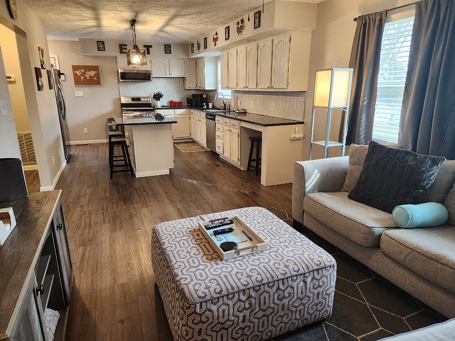 Cozy livingroom with the most comfortable sectional. Open to the kitchen. Large 55" tv to watch all your subscription streaming on.