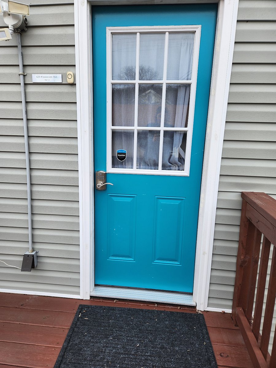 Exterior/side private entrance. This exits into the private yard. There is also a point of egress into the interior door into the shared hallway.