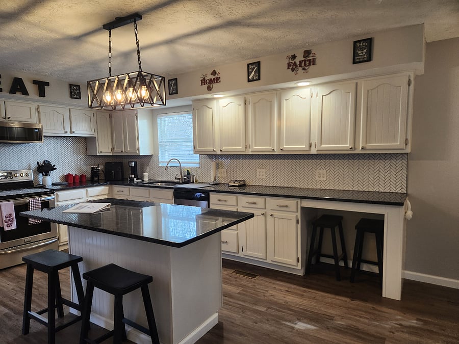 Amazing kitchen!! So much cabinets and counter space. Bar stools to sit at island for 4, plus tv trays if needed. Amazing lighting over counters and island. Open floor plan to livingroom.