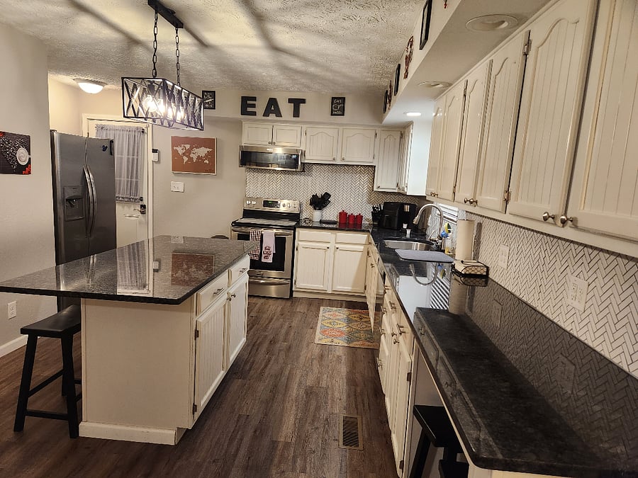 Amazing kitchen!! So much cabinets and counter space. Bar stools to sit at island for 4, plus tv trays if needed. Amazing lighting over counters and island. Open floor plan to livingroom.
