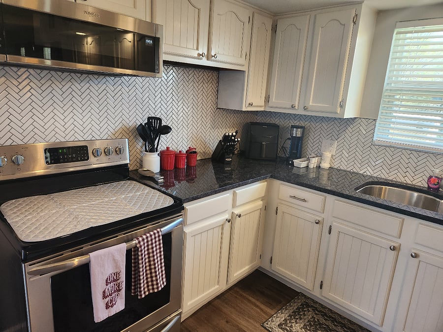 Beautiful granite counters and tile backsplash. Every detail is thought out. All small appliances, serveware, bakeware, linens, etc. are provided