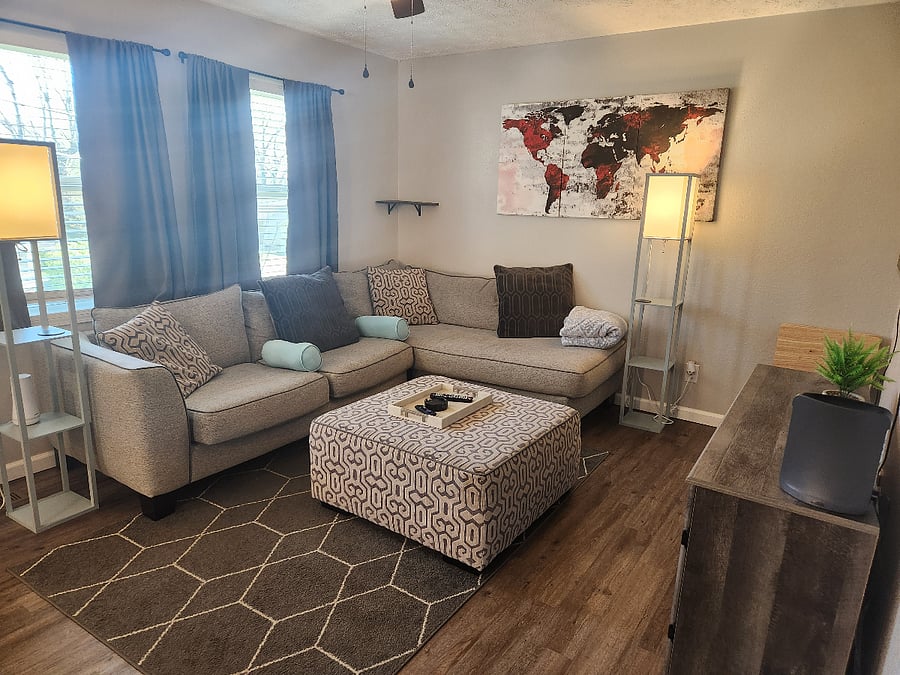 Cozy livingroom with the most comfortable sectional. Open to the kitchen. Large 55" tv to watch all your subscription streaming on.