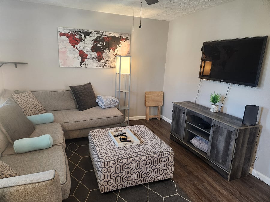 Cozy livingroom with the most comfortable sectional. Open to the kitchen. Large 55" tv to watch all your subscription streaming on.