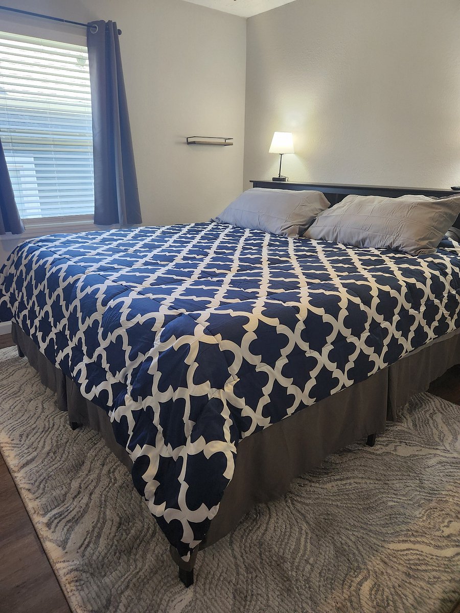Bedroom 1 with king size bed, bookcase headboard, dresser and large closet.