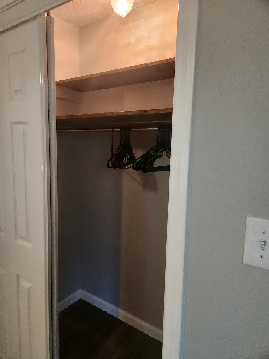 Bedroom2 closet with provided hangers. Light in closet.