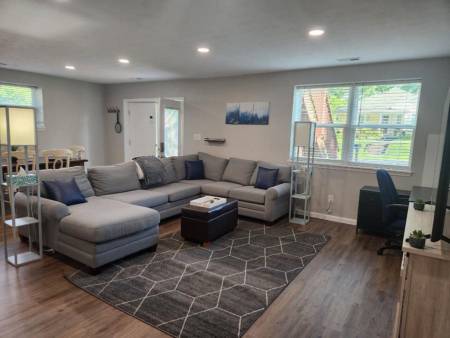 Huge, comfy sectional couch for evening movies or afternoon naps! Open floor plan to dining and kitchen. Door opens to patio where fenced yard and grill is.