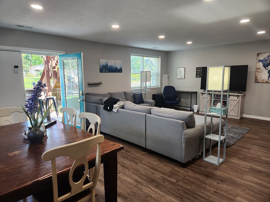 Huge, comfy sectional couch for evening movies or afternoon naps! Open floor plan to dining and kitchen. Door opens to patio where fenced yard and grill is.