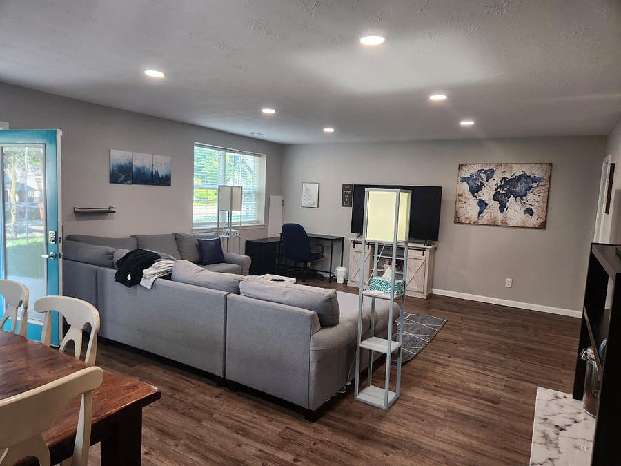 Huge, comfy sectional couch for evening movies or afternoon naps! Open floor plan to dining and kitchen. Door opens to patio where fenced yard and grill is.