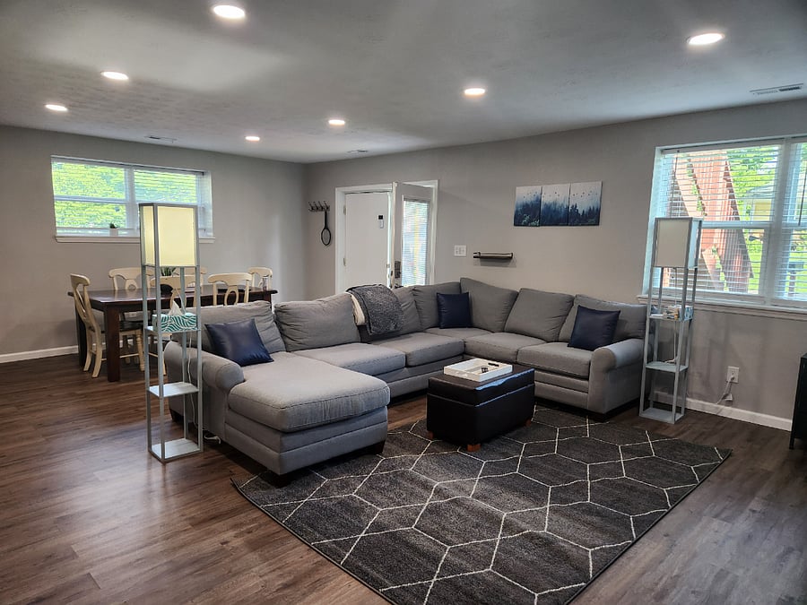Huge, comfy sectional couch for evening movies or afternoon naps! Open floor plan to dining and kitchen. Door opens to patio where fenced yard and grill is.